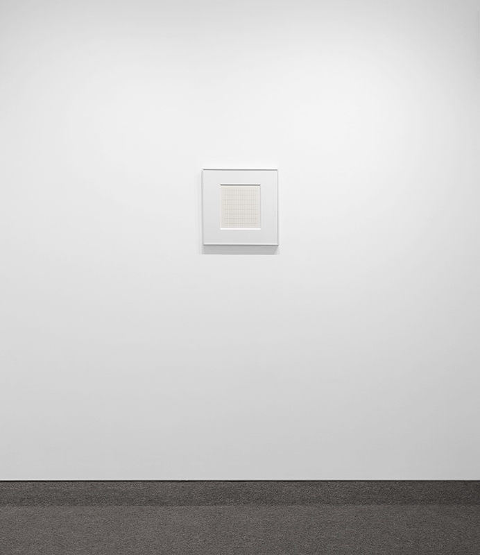 exhibition view of a white frame with a grid on paper by Agnes Martin